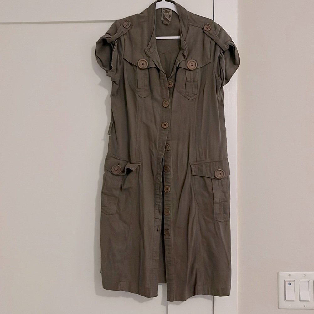Light brown shirt dress with chest and side pockets. Above knee length.